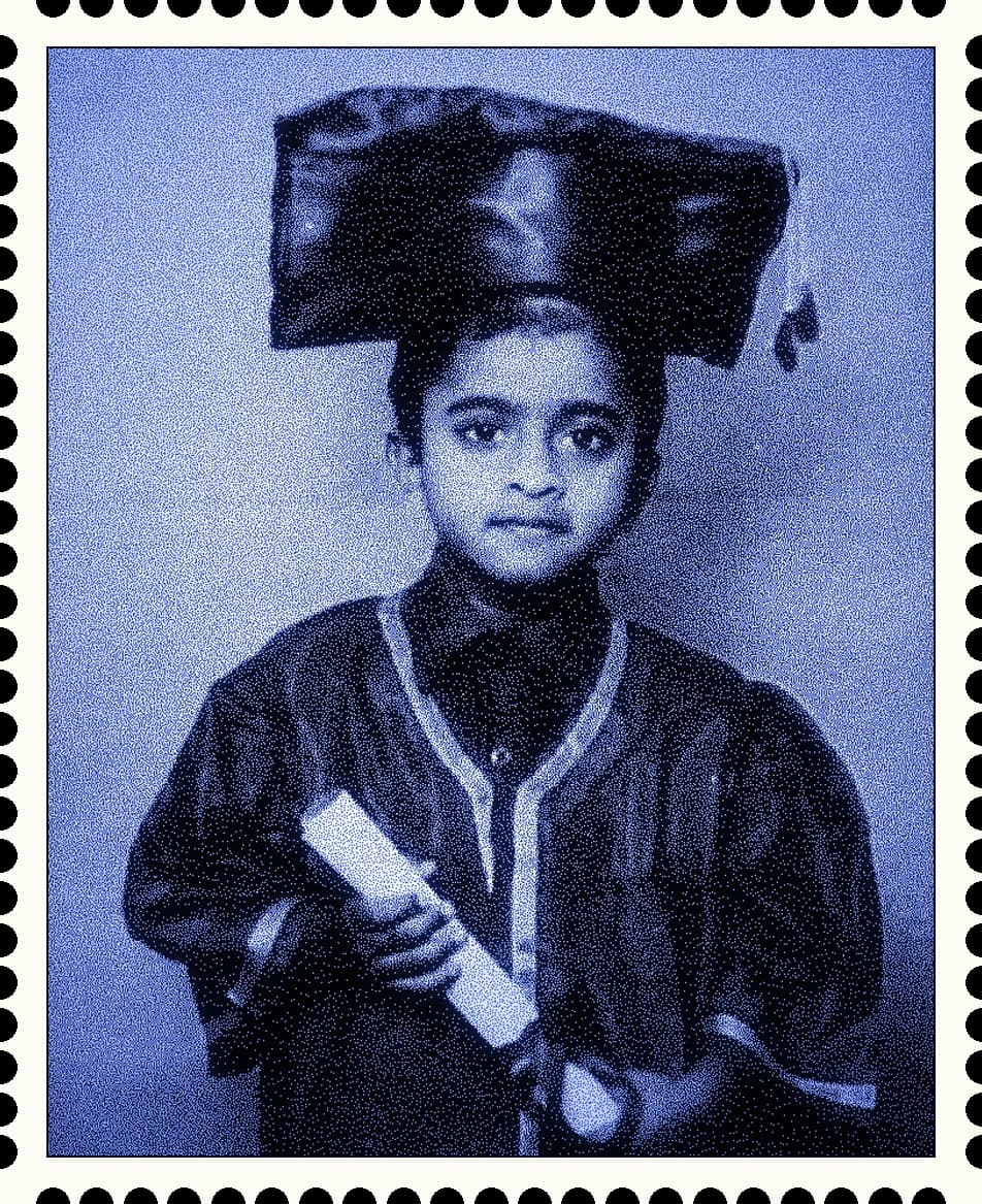 A postage stamp of a young graduate in cap and gown, holding a rolled diploma